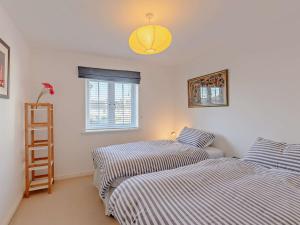 two beds in a room with a window at 3 Bed in Camber BT011 in Camber