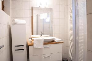 a bathroom with a sink and a mirror at Appartement zur Gemütlichkeit - Ski Juwel im Alpbachtal in Wörgl +9 photos