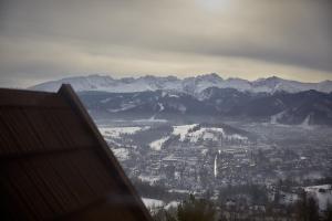 - une vue sur une ville avec des montagnes enneigées dans l'établissement Widok Apartamenty Zakopane, à Zakopane
