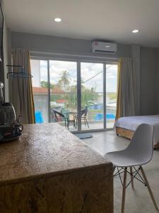 a bedroom with a bed and a view of a patio at 365 View Point Resort in Kaki Bukit