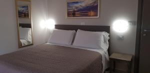 Postel nebo postele na pokoji v ubytování Hotel Margherita Meublè