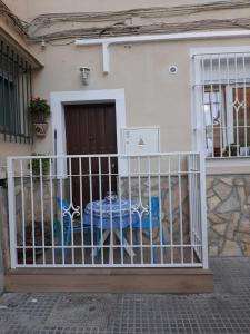 a gate with a table in front of a house at Casa El Capitán in Málaga