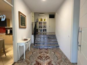 a hallway with a staircase in a house at Welc-ōM Luxury Hillside Retreat in Galzignano +24 photos