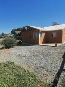 a home with a large yard in front of it at Cabaña El Quillay in Linares