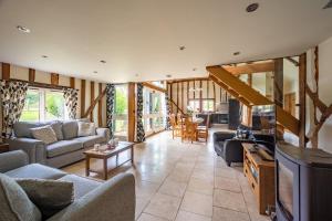 a living room with couches and a tv at Moles Meadow in Middleton