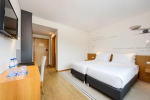 Postel nebo postele na pokoji v ubytování TRYP by Wyndham Leiria