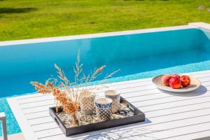a tray of fruit on a table next to a pool at Villa Averto Irene in Ráchi