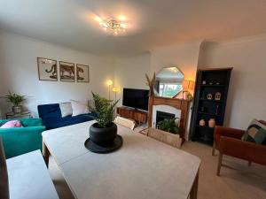 a living room with a couch and a table at Entire 4-bed, near town centre in Falmouth