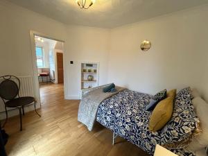 a bedroom with a bed and a chair in it at Entire 4-bed, near town centre in Falmouth
