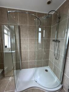 a shower with a glass door in a bathroom at Entire 4-bed, near town centre in Falmouth