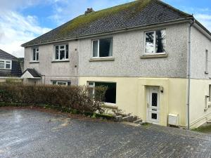 a house on the side of a street at Entire 4-bed, near town centre in Falmouth