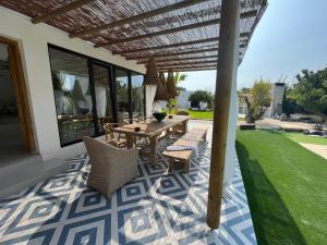 a patio with a table and chairs on a patio at CasaNoa Luxury Villa Bed and Breakfast in Jávea