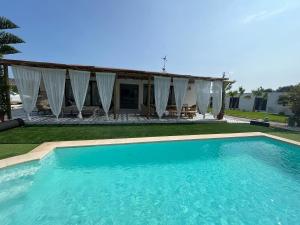 a large swimming pool in front of a house at CasaNoa Boutique Guest Suites in Jávea