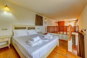 Un dormitorio con una cama con toallas blancas. en Harmony Villa, near Heraklion, en Achlada