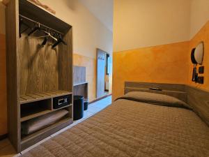 a bedroom with a bed with a wooden headboard at Hotel Euro in Castegnato