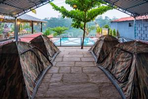 a group of tents sitting on top of a walkway at Dandeli Kali River Resort in Dandeli