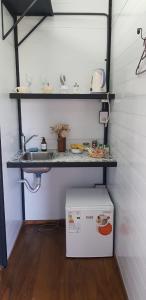 a small kitchen with a sink and a refrigerator at Cantal Bed & Breakfast in El Durazno