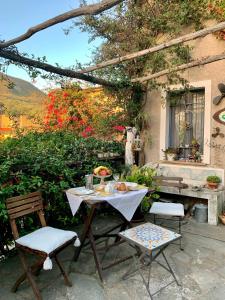 a table and two chairs and a table and a table and chairs at B&B Cà de Badin in Noli