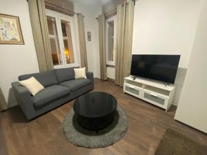 a living room with a couch and a flat screen tv at Nokturno Accomodation in Zagreb