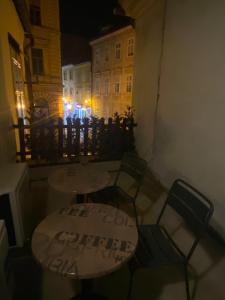 a table and two chairs and a table with writing on it at Nokturno Accomodation in Zagreb