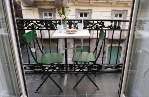 a balcony with a table and chairs on a balcony at Toledo 292 Luxury House in Naples