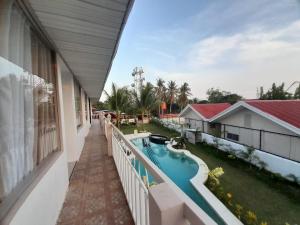 a balcony view of a swimming pool on a house at Francisco Resort in Panglao