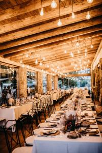 un comedor largo con mesas y sillas blancas en Hotel rural Finca Vivaldi Nature & Spa, en San Miguel de las Dueñas