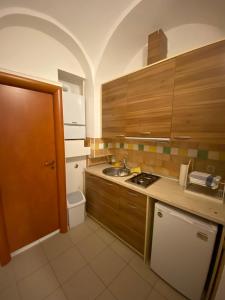 a small kitchen with a sink and a stove at Nokturno Accomodation in Zagreb