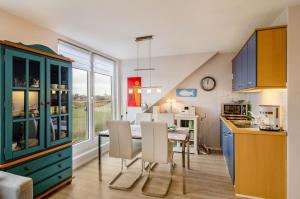 a kitchen and dining room with a table and chairs at Ferienhaus Raschke in Norderney
