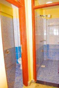 a bathroom with a shower and a toilet at Lighthomes Two Bedroom Thika CBD in Thika