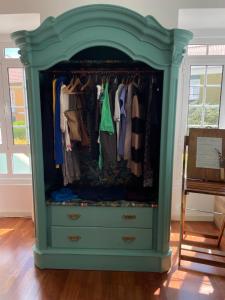 a blue closet with a dresser in a room at Impact Beach House in Estoril