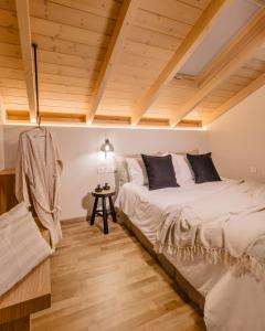 sypialnia z 2 łóżkami i drewnianym sufitem w obiekcie PAPADRIA VILLAS - Modern Luxury villas near Kathisma Beach w mieście Tsoukalades +37 zdjęć