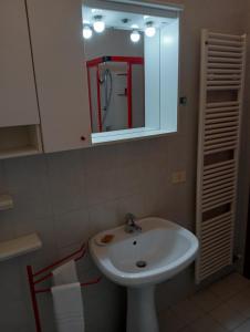 a bathroom with a white sink and a mirror at Residenza Camilla in Vicenza