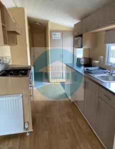 A kitchen or kitchenette at 3 Bedroom Caravan for Hire Butlins Minehead