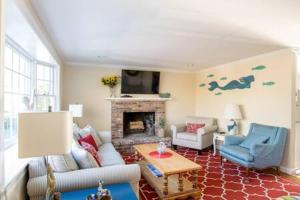 a living room with a couch and a fireplace at Central AC Close to Beach Dog Friendly! in Chatham