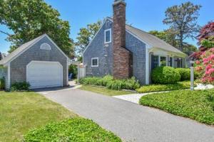a brick house with a garage and a driveway at Central AC Close to Beach Dog Friendly! in Chatham