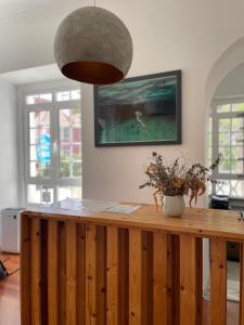 a room with a wooden counter with a pendant light at Impact Beach House in Estoril