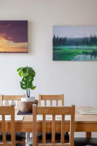 a dining room table with a potted plant on it at Spacious & Central 3-bed flat by popular Waterloo! in London