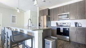 a kitchen with stainless steel appliances and a counter top at Landing Modern Apartment with Amazing Amenities (ID4496) in Jacksonville