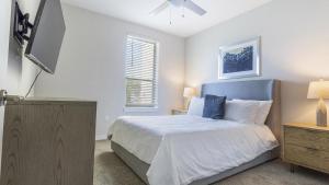 a bedroom with a bed and a flat screen tv at Landing Modern Apartment with Amazing Amenities (ID4496) in Jacksonville