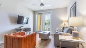 a living room with a couch and a tv at Landing Modern Apartment with Amazing Amenities (ID4496) in Jacksonville