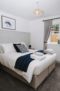 a bedroom with a large bed with a window at Woodhaven Stays in Scredington