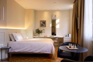 a hotel room with a bed and a table at Vrachos Athens Suites in Athens