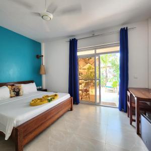 a bedroom with a bed with bananas on it at Olzadia Boutique Hotel in Michamvi