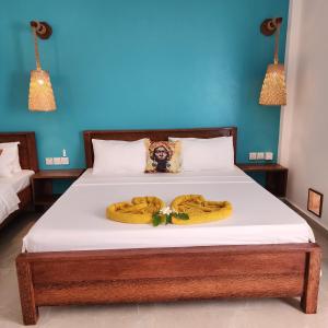a bedroom with a bed with two towels on it at Olzadia Boutique Hotel in Michamvi