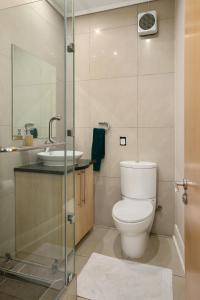 a bathroom with a toilet and a sink at Hydro Park Residences in Sandton WITH GENERATOR in Johannesburg