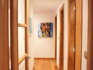 a hallway with a painting on the wall at Apartamento Centro de Pontevedra in Pontevedra +36 photos
