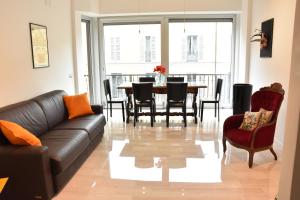 a living room with a couch and a table and chairs at Appartamenti Bruzzanese in Milan