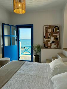 a bedroom with a bed and a view of the ocean at Agia Fotia Taverna in Kerames