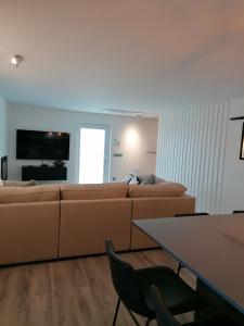 ein Wohnzimmer mit Sofa und Tisch in der Unterkunft Casa de Férias do Parque da Peneda 2 in Vila Verde + 49 Fotos